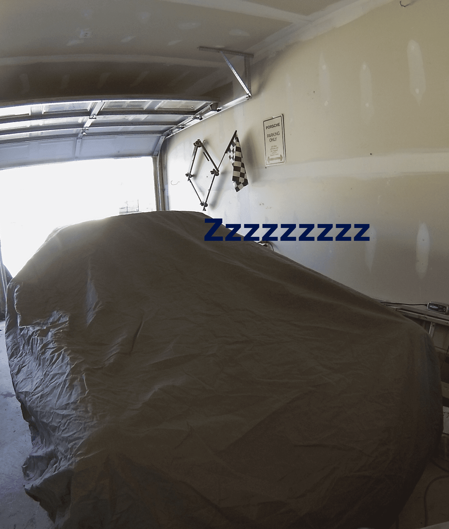 Car under a protective cover, stored in a garage for the winter
