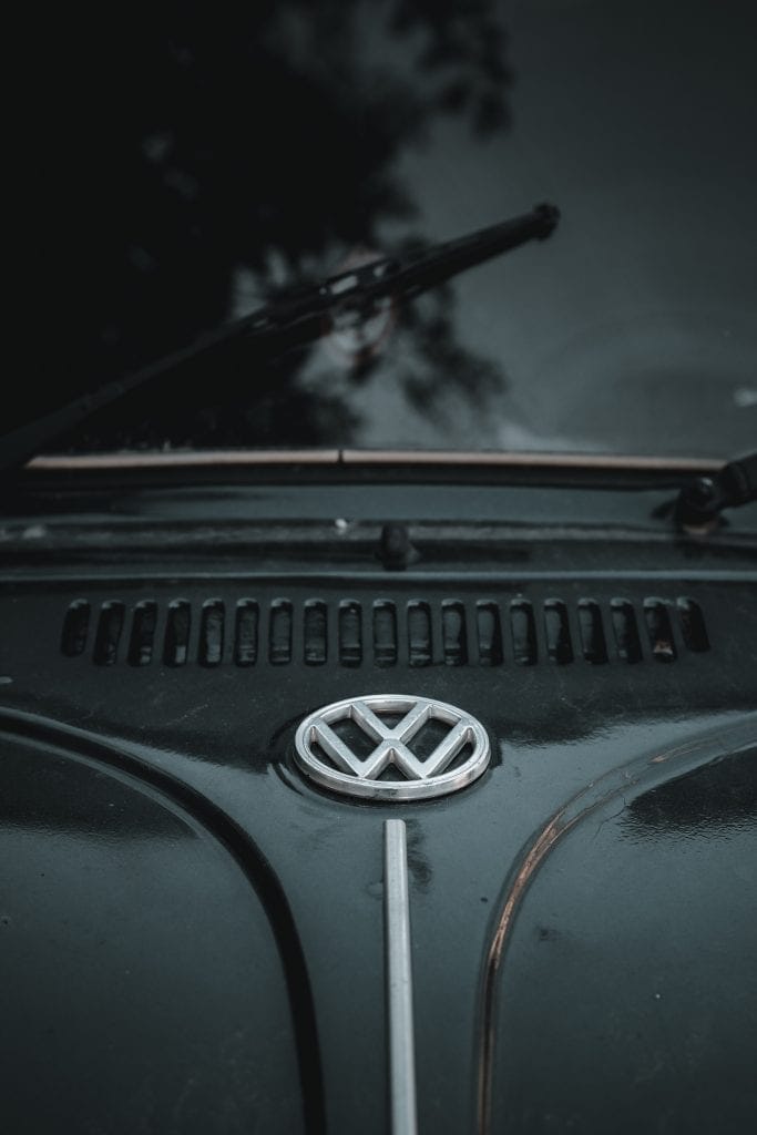 Volkswagen badge on the hood of a dark classic Beetle
