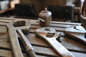 Old wrenches and tools on a workbench