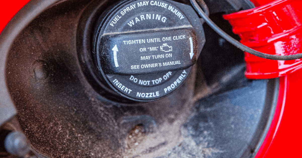 Car gas tank door open with view of gas cap