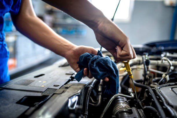 Mechanic checking engine oil