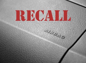 Vehicle recall word on top of image of dash with airbag letters on it