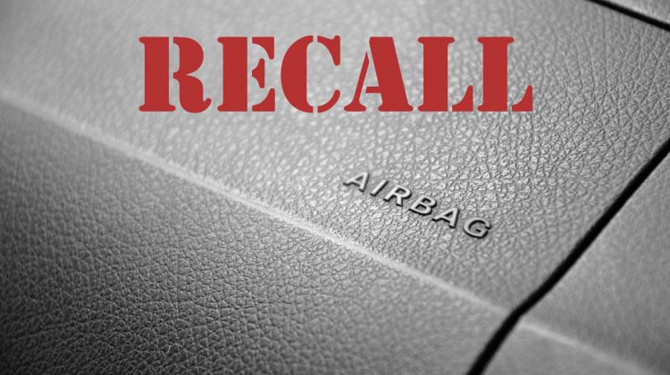 Vehicle recall word on top of image of dash with airbag letters on it