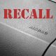 Vehicle recall word on top of image of dash with airbag letters on it
