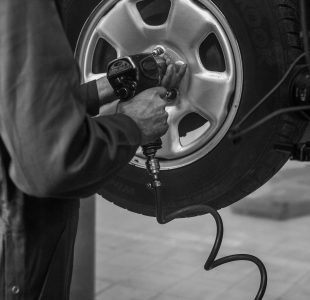 mechanic changing wheel on car