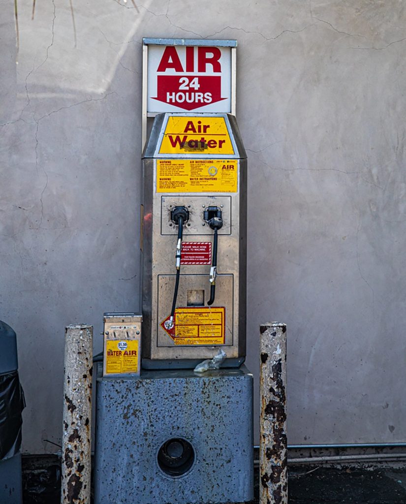 A coin-operated air pump at a gas station