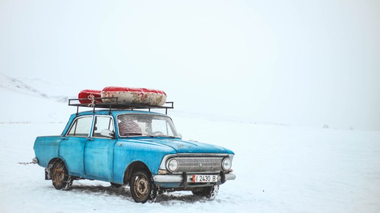 old car in a desolate snowy environment
