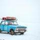 old car in a desolate snowy environment