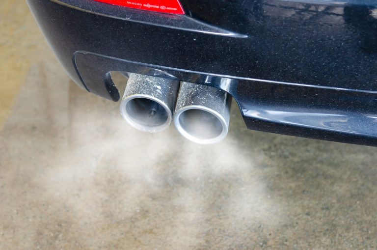 Car exhaust pipe with smoke coming out